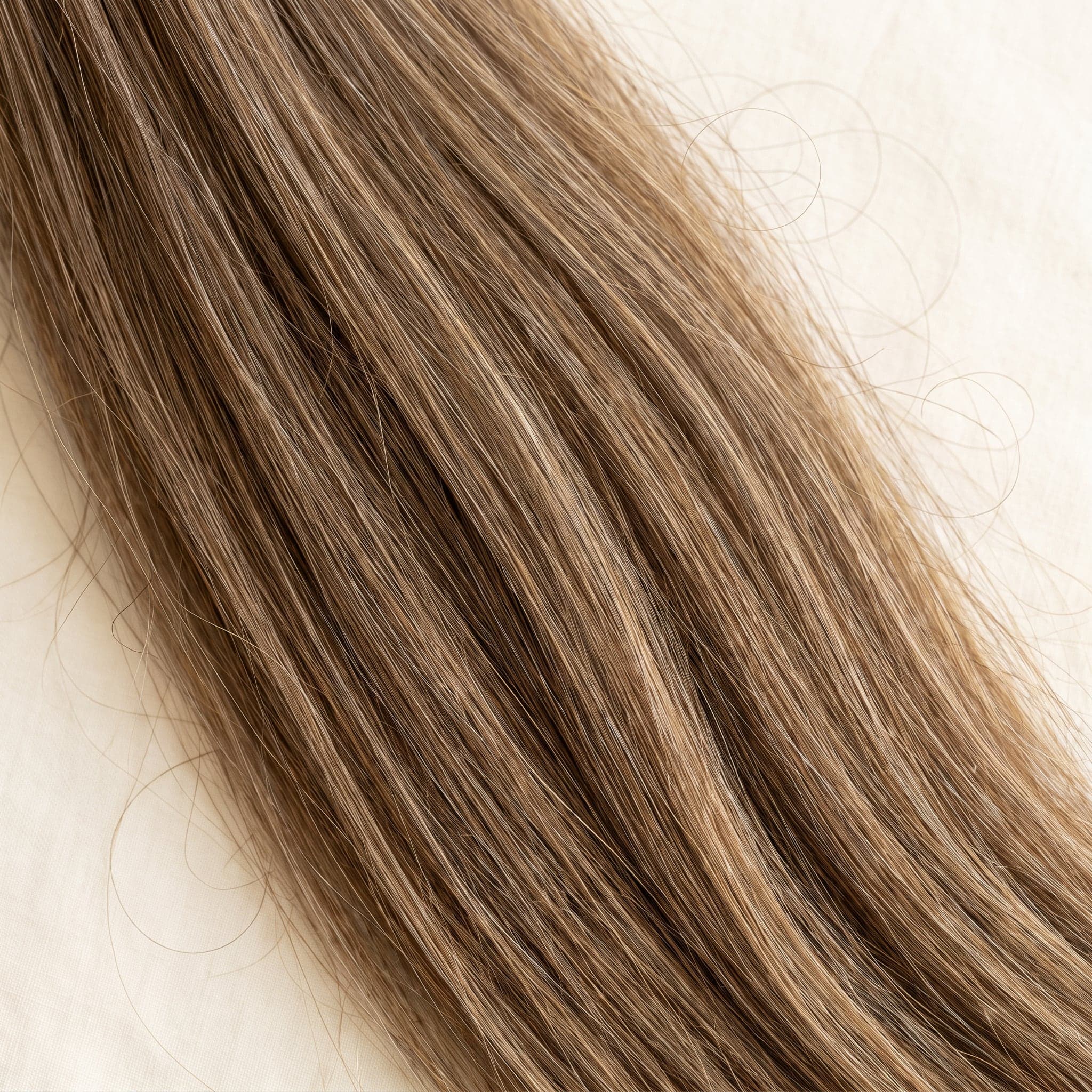 Close-up of Premium grade hair in natural blonde and light brown tones showing softness and strand detail